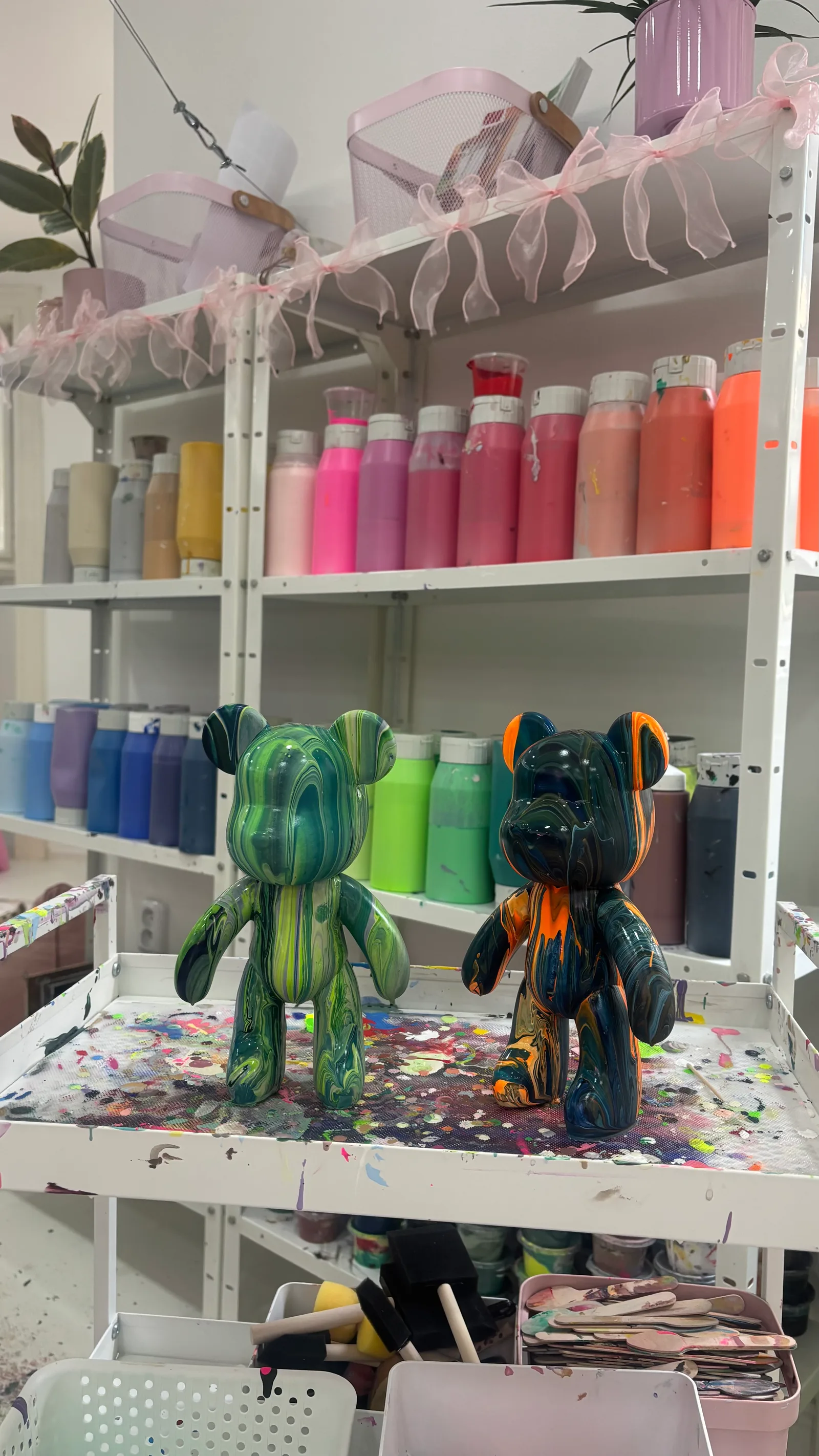 Shelves with acrylic paints at No Limit Art studio Brno